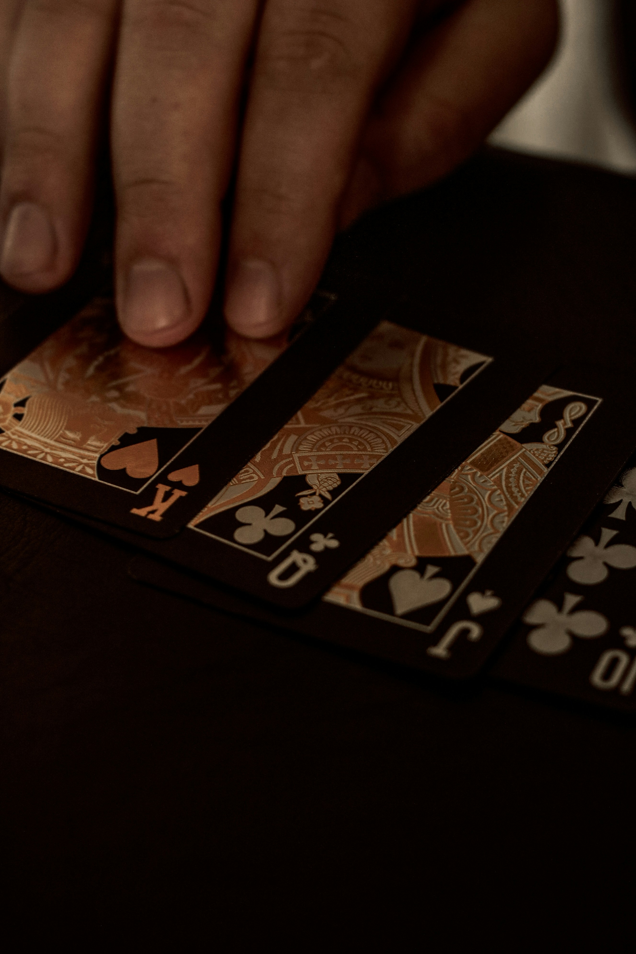 a person is playing cards on a table